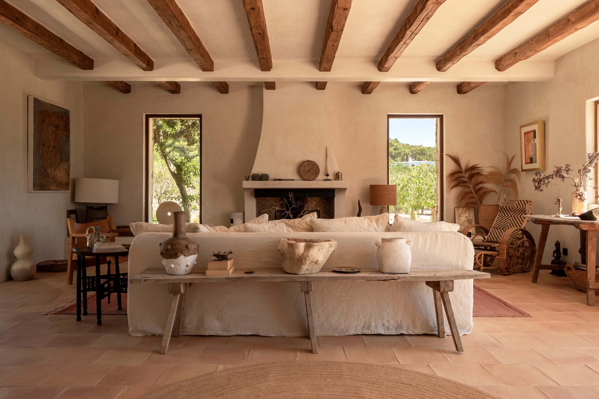 Living room with exposed timber ceiling beams and a stone fireplace
